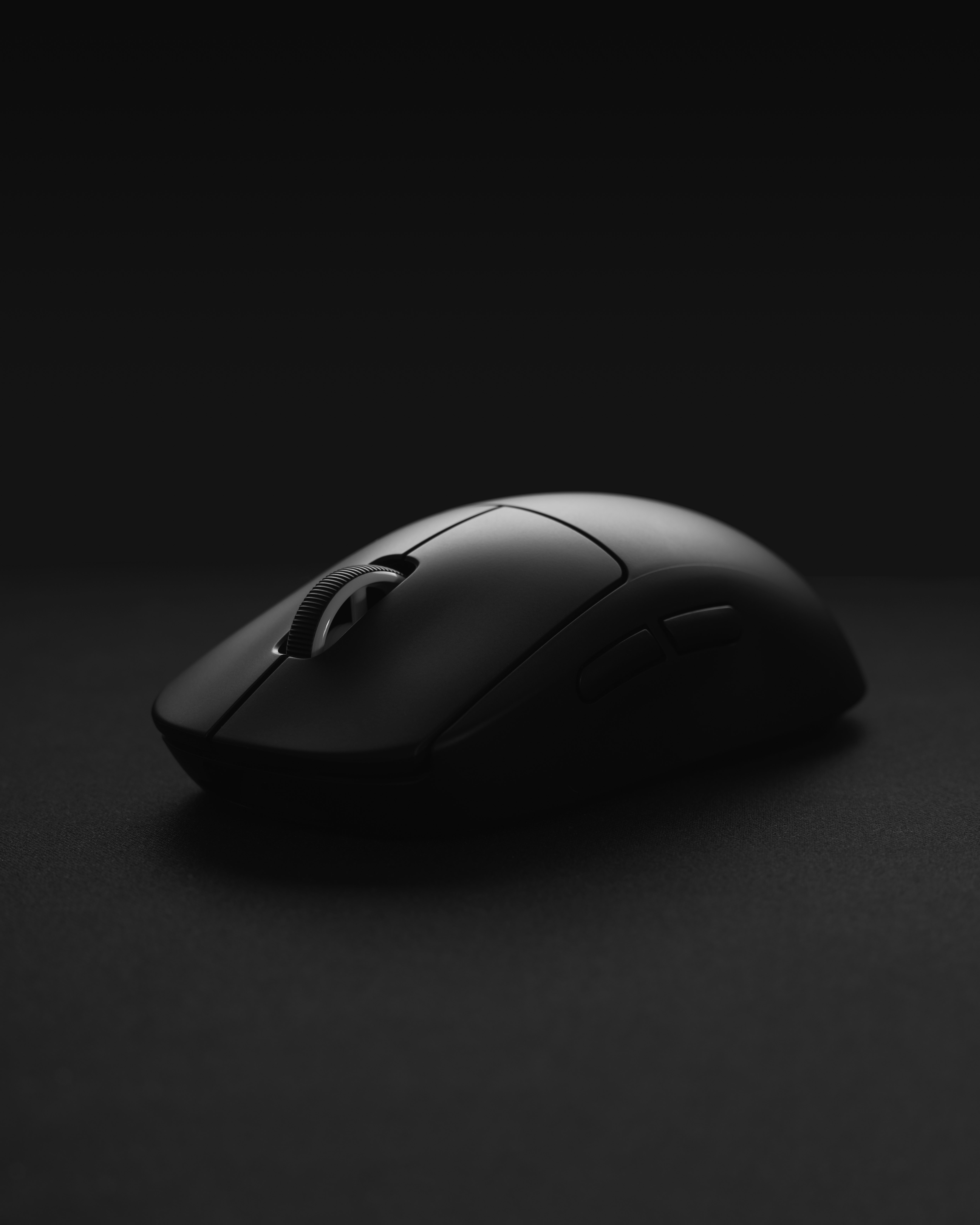 black cordless computer mouse on black surface